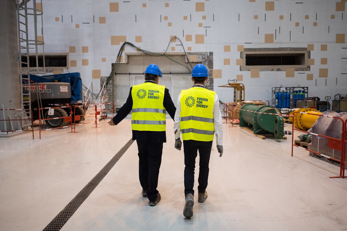 ITER members walk towards the entrance of the Takomak in the assembly hall during the launch of the assembly stage of nuclear fusion machine "Tokamak" of the International Thermonuclear Experimental Reactor (ITER) in Saint-Paul-les-Durance, southeastern France, on July 28, 2020. Thirty-five nations are collaborating in the ITER energy project aimed at mastering energy production from hydrogen fusion, as in the heart of the sun, a potential new source of carbon-free and non-polluting energy. (Photo by CLEMENT MAHOUDEAU / AFP)